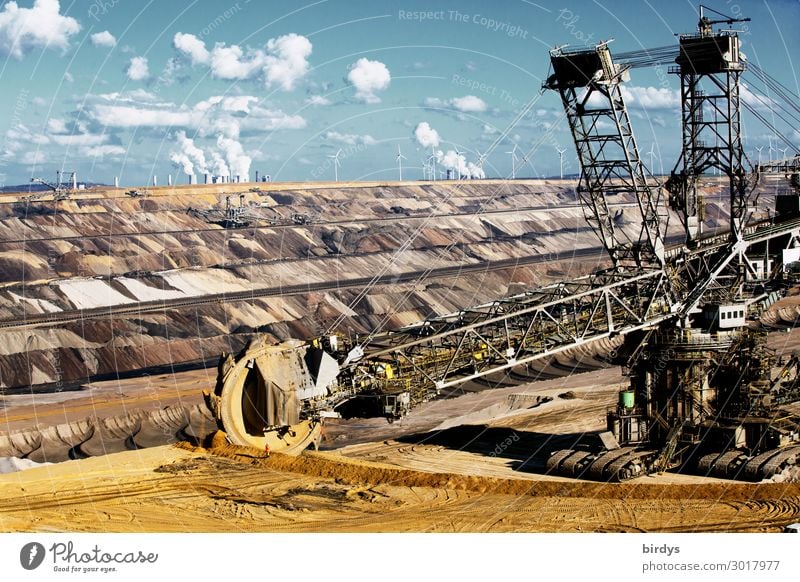 Bucket-wheel excavator in the Garzweiler 2 open-cast lignite mine, lignite-fired power plants in the background Soft coal mining bucket wheel excavator co2