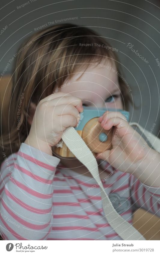 Toy Photo Girl Lens Feminine 1 Human being 1 - 3 years Toddler Striped Brunette Short-haired Bangs Discover To hold on Playing Curiosity Cute Beautiful Joy