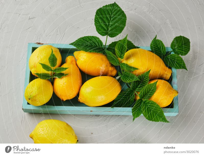 fresh ripe whole yellow lemons on a blue wooden board Fruit Vegetarian diet Diet Lemonade Juice Summer Table Nature Leaf Wood Fresh Natural Juicy Blue Yellow