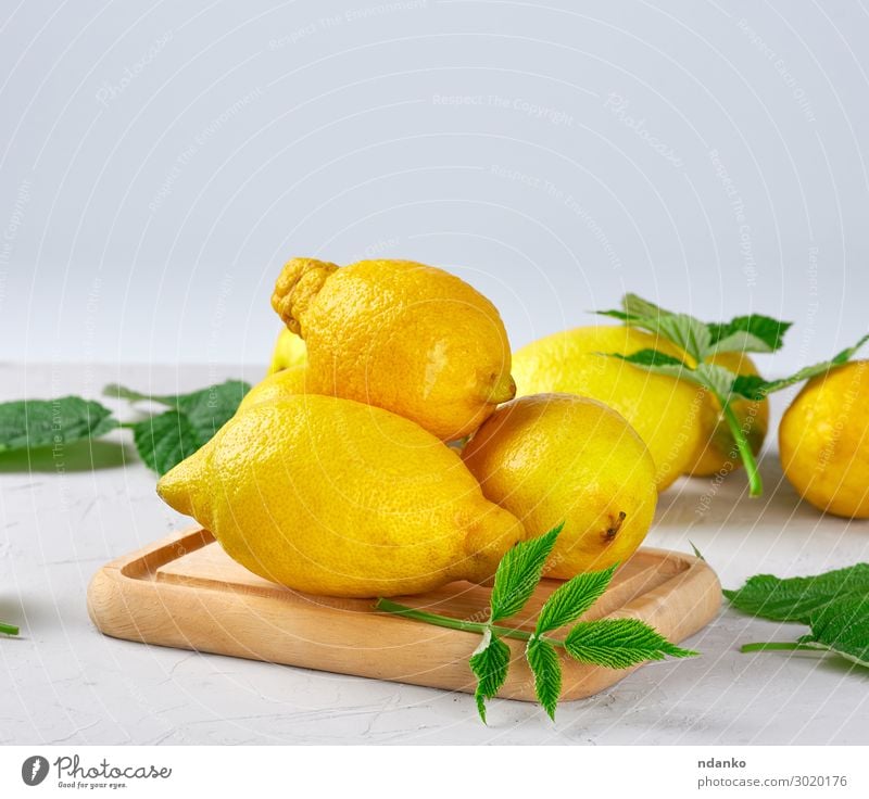 fresh ripe whole yellow lemons Fruit Vegetarian diet Diet Lemonade Juice Summer Table Nature Leaf Wood Eating Fresh Natural Juicy Yellow Green White Colour