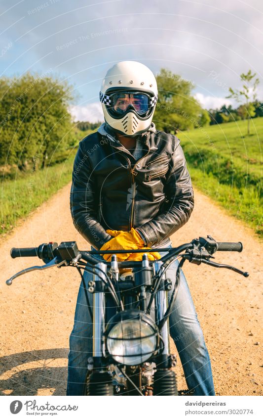 Man with helmet riding custom motorbike Lifestyle Engines Human being Adults Grass Transport Street Lanes & trails Vehicle Motorcycle Fashion Jeans Gloves Sit