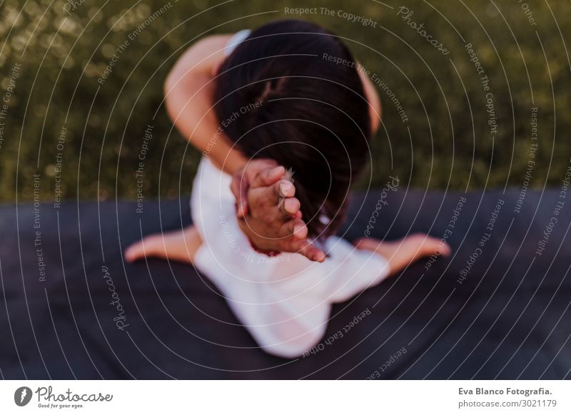 young beautiful asian woman doing yoga in a park at sunset. Lifestyle Happy Beautiful Body Harmonious Relaxation Meditation Summer Music Sports Yoga Feminine