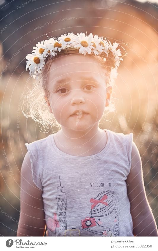 Little girl wearing a coronet of wild flowers on her head Lifestyle Joy Happy Relaxation Leisure and hobbies Playing Vacation & Travel Summer Child Human being