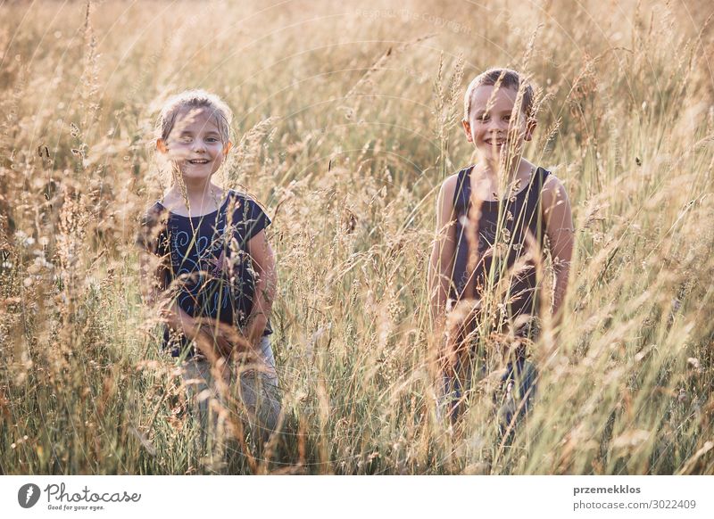 Little happy smiling kids playing in a tall grass Lifestyle Joy Happy Relaxation Vacation & Travel Summer Summer vacation Child Human being Girl Boy (child)