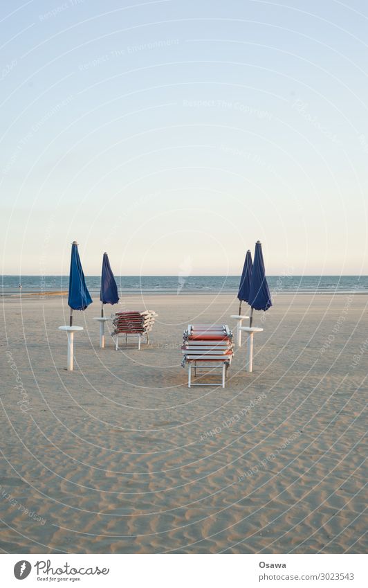 stacked sun beds and closed umbrellas on the beach Sunshade sun lounger Beach Ocean coast Sand Vacation & Travel Summer Exterior shot Summer vacation