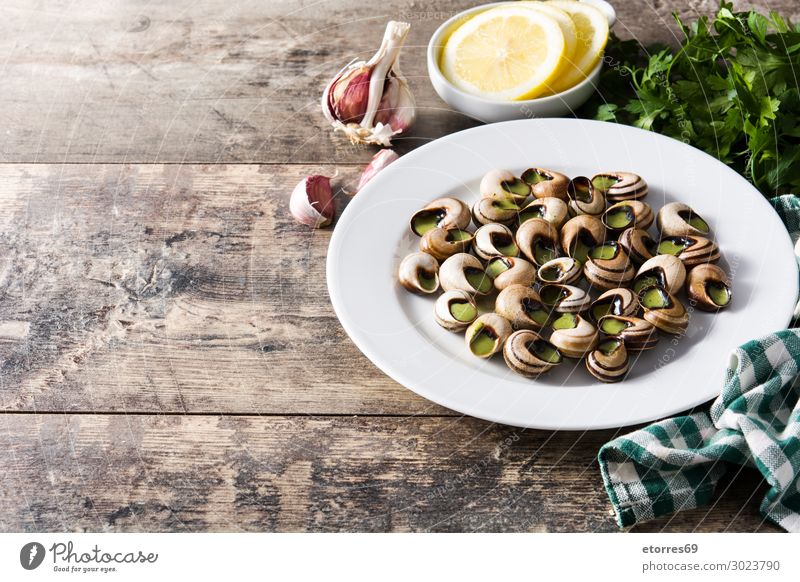 Escargots de Bourgogne on wooden table Burgundy Cooking Diet Dinner eat escargots escargots de bourgogne Food Healthy Eating Food photograph French Fresh Garlic