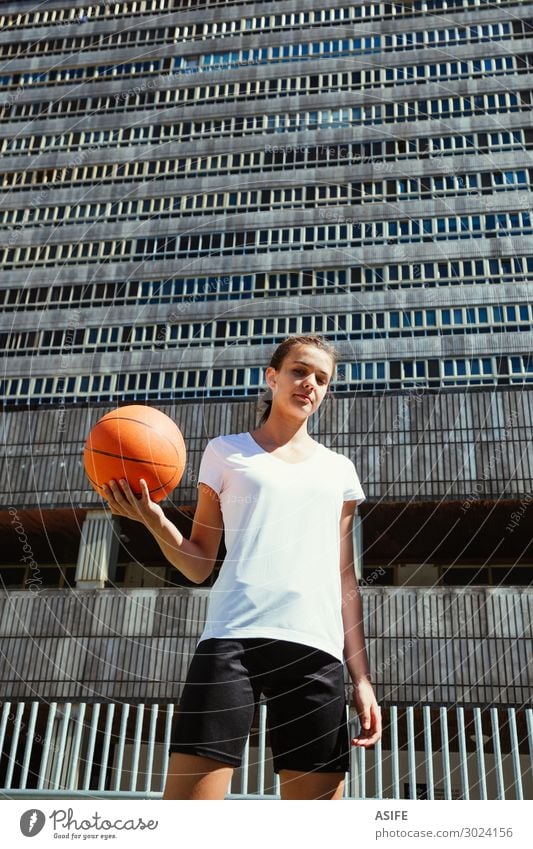 Young female basketball player in an urban court Lifestyle Beautiful Playing Sports Woman Adults Youth (Young adults) Park High-rise Street Tall Cute girl