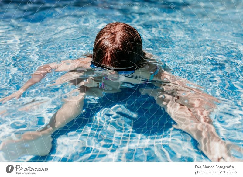 beautiful kid girl at the pool diving with water goggles.Summer Lifestyle Joy Swimming pool Leisure and hobbies Playing Vacation & Travel Sports Dive Child