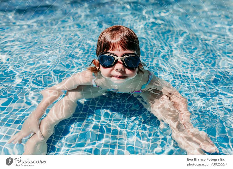 beautiful kid girl at the pool diving with water goggles.Summer Joy Swimming pool Leisure and hobbies Playing Vacation & Travel Sports Dive Child Human being