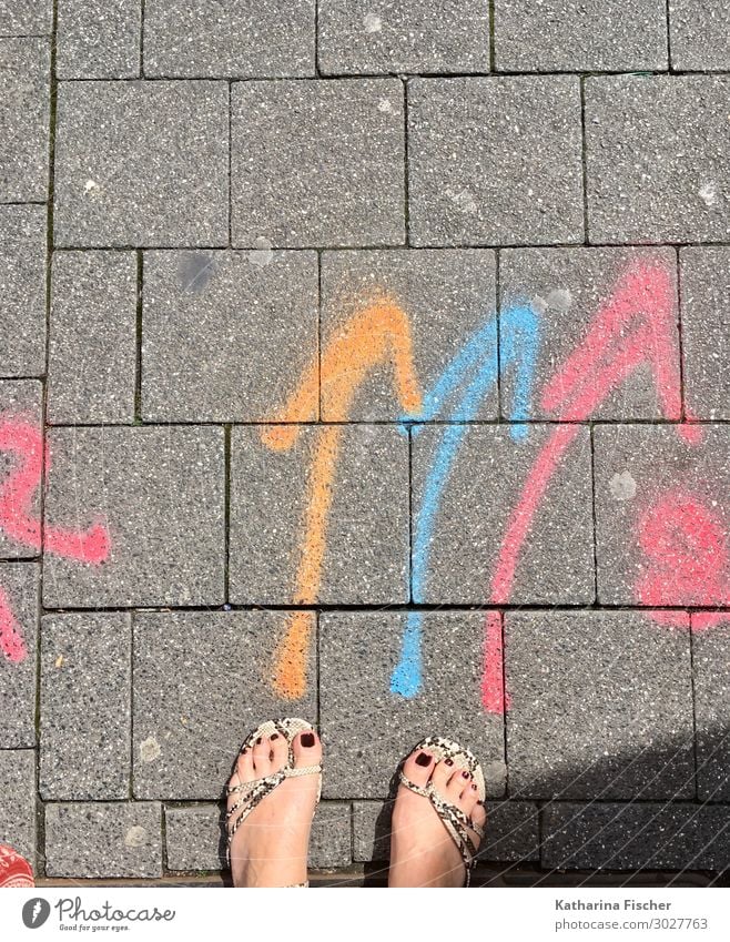 coloured arrows on the street Sign Characters Signage Warning sign Graffiti Blue Gray Orange Pink Red Turquoise White Lanes & trails Feet Chalk Pavement