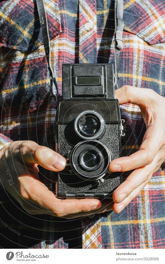 Closeup of man's hands holding vintage camera Retro Capture Exterior shot Photography shoot Old plaid shirt Faceless Lens Photographer Film Hold Hand Man Camera