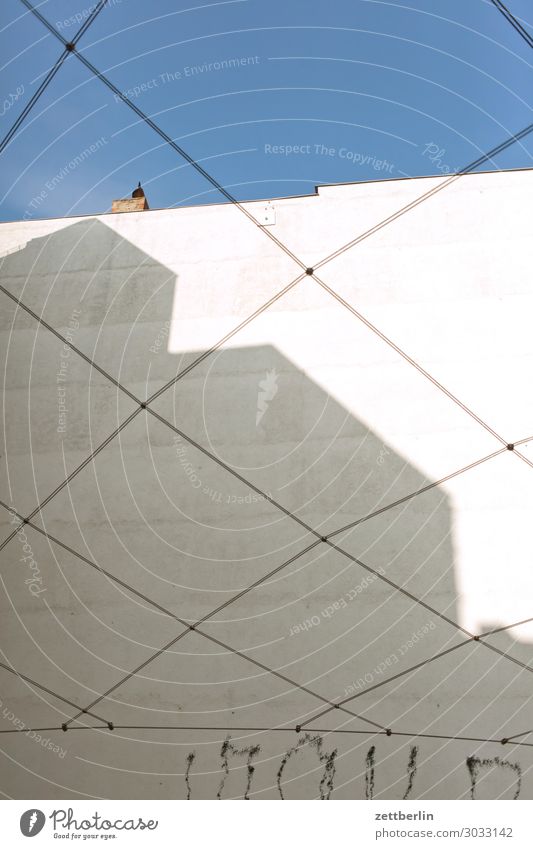 Rear building with rope mesh Old building Fire wall Facade Worm's-eye view House (Residential Structure) Sky Heaven Blue sky Sky blue Behind Alley Rear view