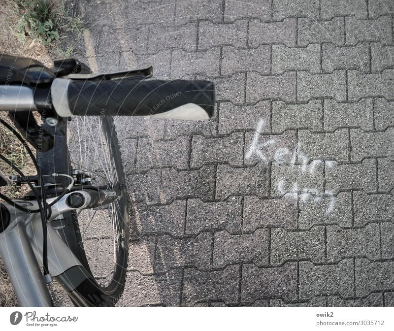 street sermon Transport Traffic infrastructure Cycling Cycle path Bicycle Bicycle handlebars Wheel Paving stone Stone Concrete Metal Plastic Sign Characters