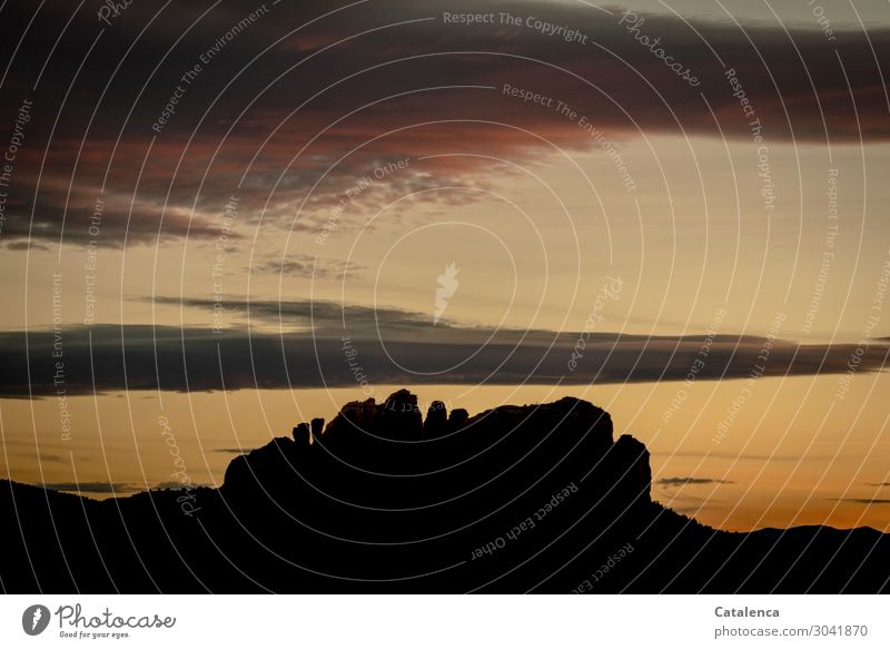 Silhouette of a rock formation stands out from the evening sky Mountain Hiking Nature Landscape Sky Clouds Horizon Sunrise Sunset Hill Rock Desert Old Authentic