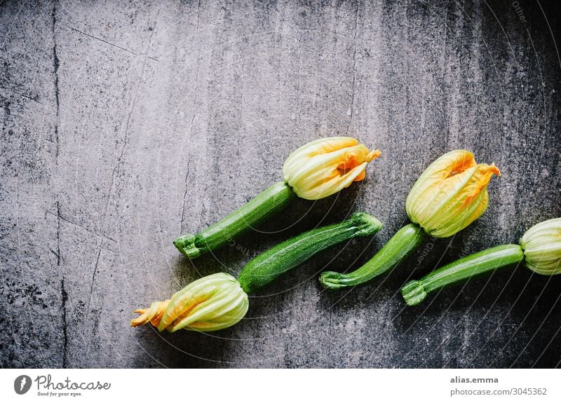 Zucchinis with flowers on stone plate Food Vegetable Nutrition Lunch Dinner Organic produce Vegetarian diet Diet Yellow Gray Green Orange Black Zucchini blossom