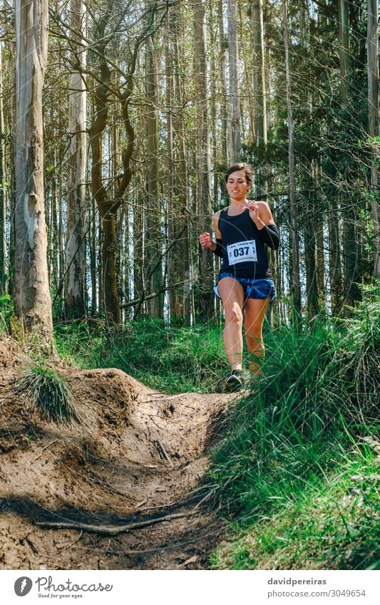 Man participating in trail race Lifestyle Sports Human being Woman Adults Nature Tree Grass Forest Lanes & trails Fitness Authentic Speed Energy Competition