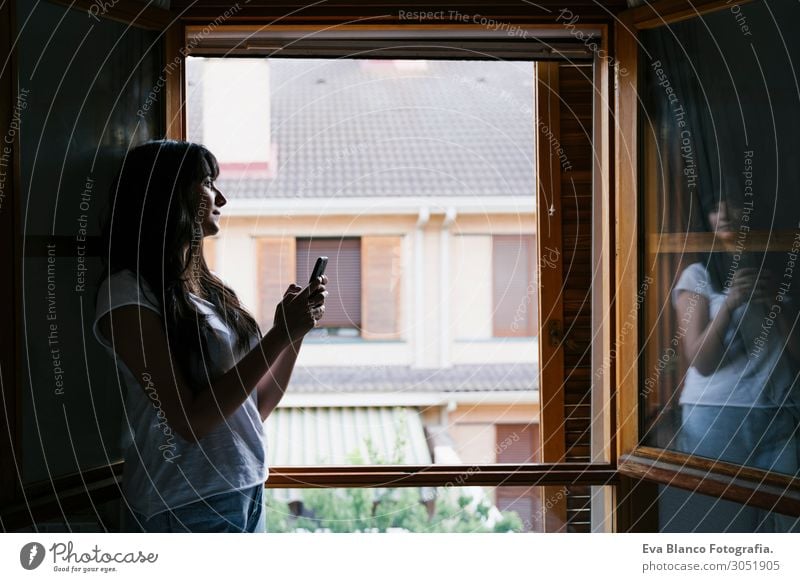 young caucasian woman by the window using mobile phone Lifestyle Happy Relaxation Leisure and hobbies Playing Reading Vacation & Travel