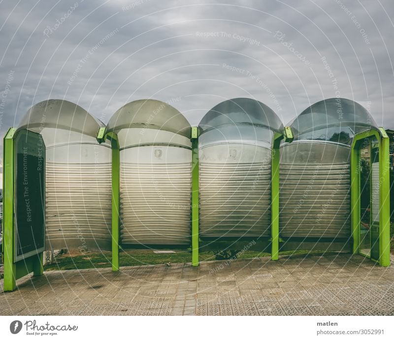 Bus stop in the mountains Storm clouds Bad weather Town Deserted Tunnel Transport Public transit Bus travel Street Modern Brown Gray Green Colour photo