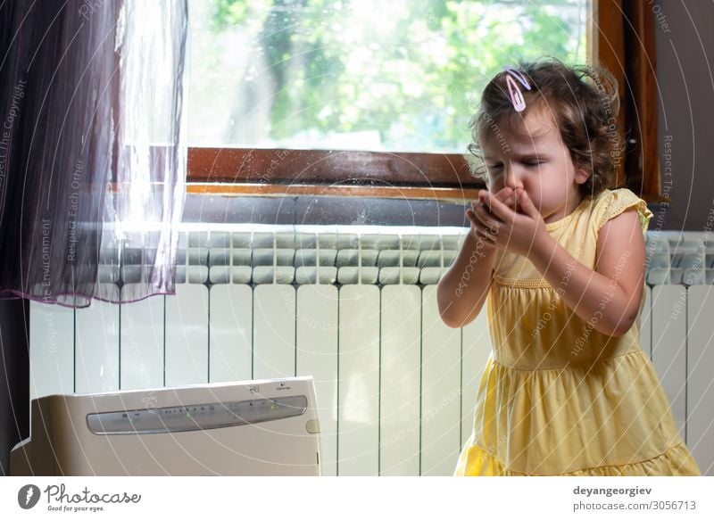 Little girl in a dusty room. Air purifier and coughing kid. Health care Child Infancy Earth Fresh Clean alergy allergen fine dust Sneezing sternutation air Home