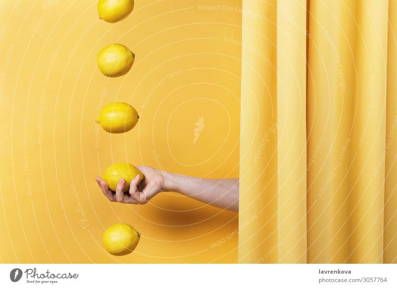 woman's hand holding a lemon Fingers Diet Vitamin C Lemon Cloth drapery Concepts &  Topics levitation Curtain Citrus fruits Fruit Summer Fresh Food