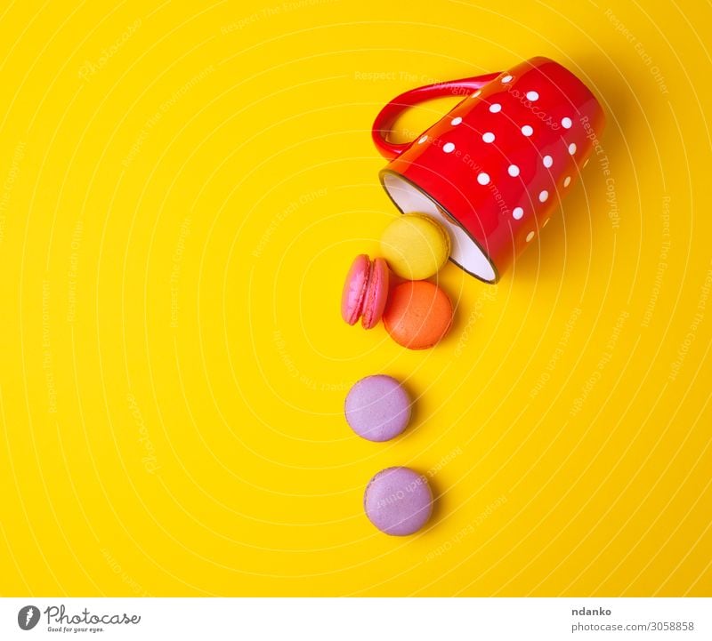 multicolored macarons falling from a red ceramic cup Cake Dessert Candy Cup Mug Eating Fresh Delicious Yellow Pink Red Colour Tradition Almond assorted