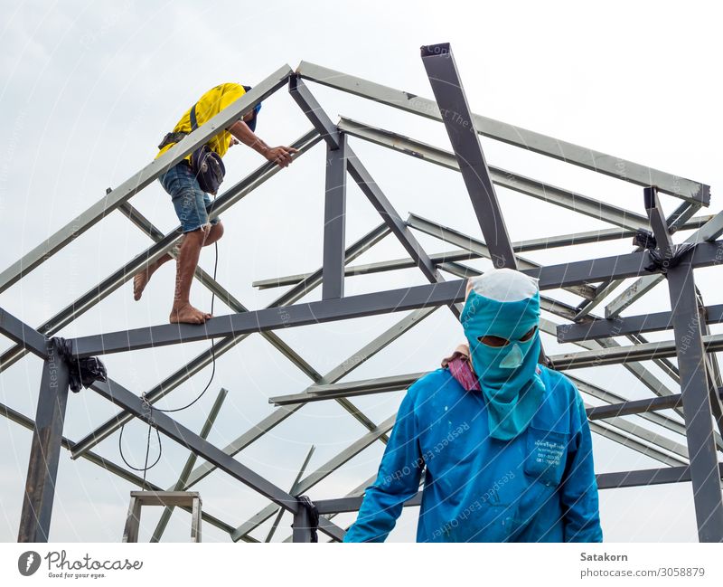 Workers working in the construction site to build a house House building Work and employment Construction site Tool Man Adults Body Head 2 Human being