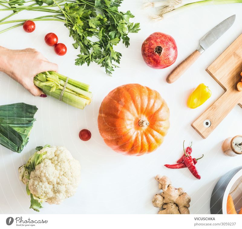 Kitchen table with vegetables and hand with celery sticks Food Vegetable Nutrition Organic produce Vegetarian diet Diet Crockery Lifestyle Design Healthy Eating