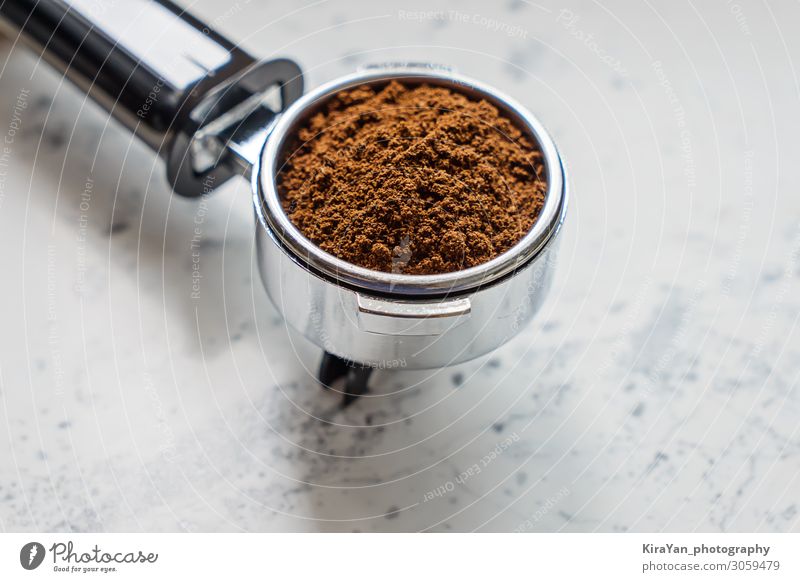 Closeup view of portafilter with ground coffee for coffee machine barista appliance aroma background beans beverage black breakfast brown cafe caffeine