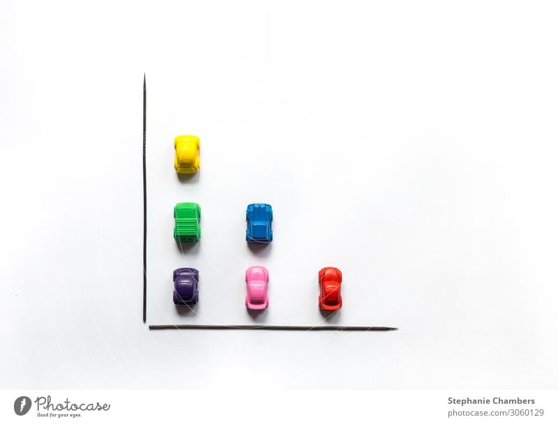 Coloured crayon cars in a bar chart flat lay. Car Multicoloured Motor vehicle colourful flatlay Graph Chart Data Crayon Colour photo