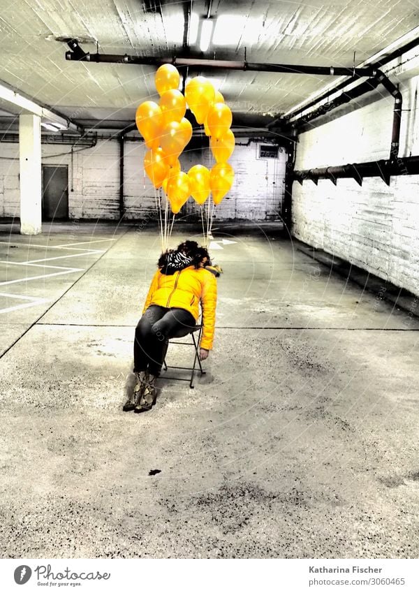 yellow balloons 1 Human being Parking garage Signs and labeling Sit Yellow Gold Gray Black White Exhaustion Chair Balloon Garage Woman Boots Denim Colour photo