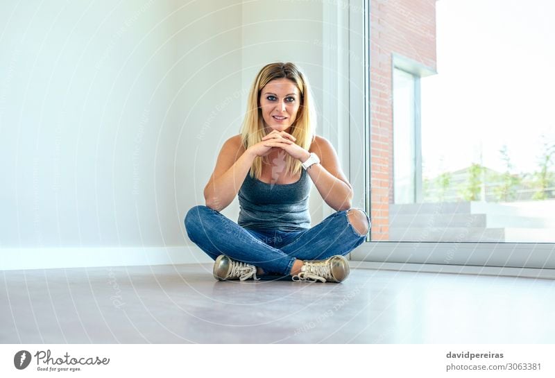 Thoughtful girl sitting in a living room Beautiful Contentment House (Residential Structure) Human being Woman Adults Hand Jeans Sneakers Blonde Wood Observe