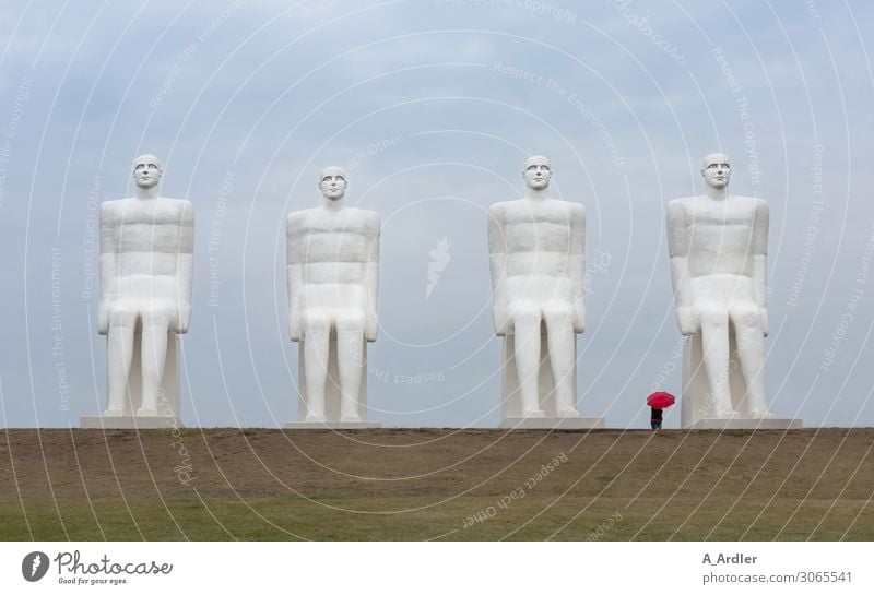 Four oversized human figures with red umbrella Art Work of art Sculpture Culture Manmade structures Tourist Attraction Landmark Monument Man by the sea Stone