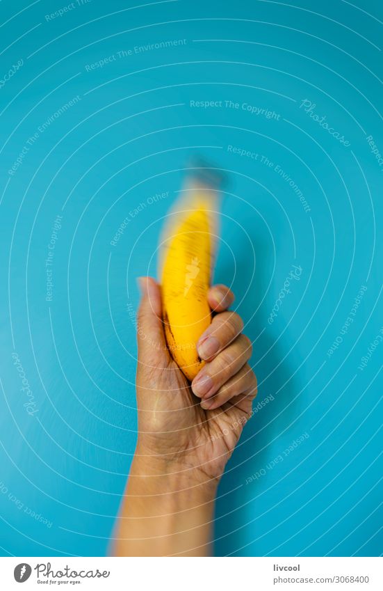 banana on blue wall Vegetable Fruit Nutrition Organic produce Vegetarian diet Diet Lifestyle Design Human being Woman Adults Arm Hand Fingers Nature Eating