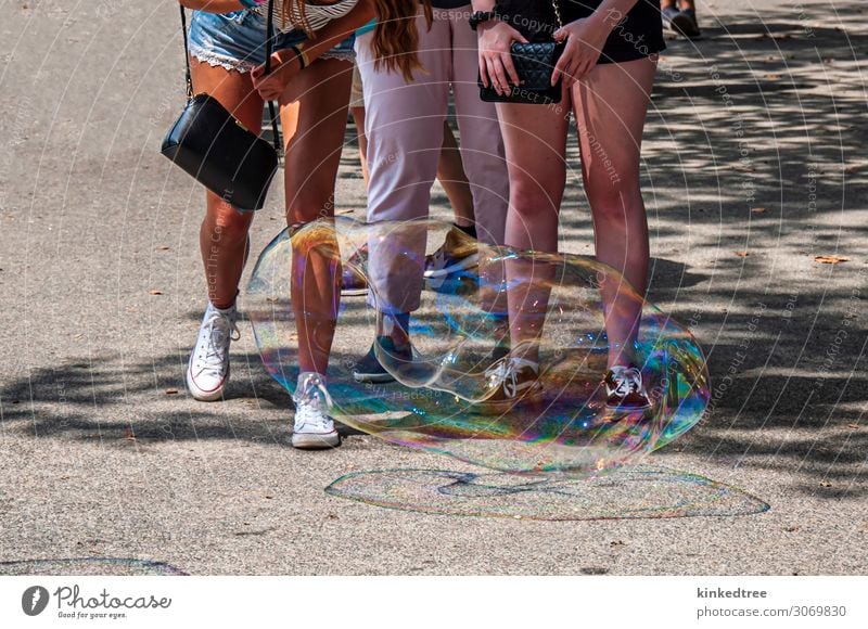 Inspecting a large bubble near the ground Summer Human being Feminine Woman Adults 3 Tree Sneakers Concrete Blue Brown Yellow Gray Green Pink Red Black White