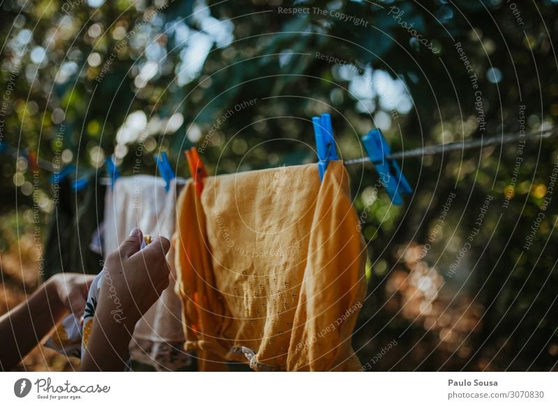 Woman hanging clothes on line Lifestyle Living or residing Human being Feminine Hand 1 18 - 30 years Youth (Young adults) Adults Clothing Work and employment