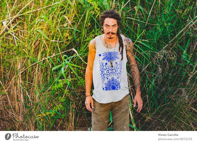 A handsome man with green eyes with a vegetation background Lifestyle Joy Happy Beautiful Relaxation Tourism Summer Beach Woman Adults Friendship