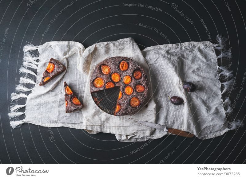 Chocolate cake with plums and dessert slices Fruit Dessert Candy Autumn Fresh above view autumn food Baking Bakery black background brownie chocolate plum cake