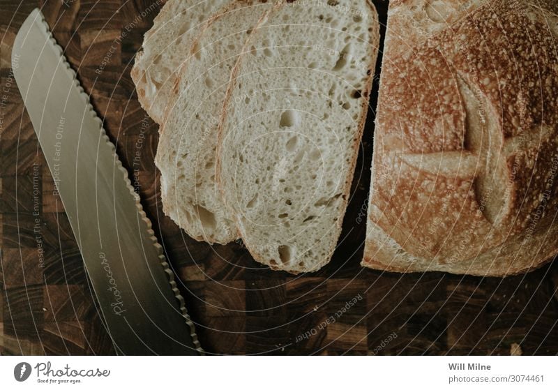 Sliced Bread and a Knife Cut Cutting tool Chopping board Knives Table-knife Carving knife Kitchen Food Healthy Eating Dish Food photograph Sandwich Baking