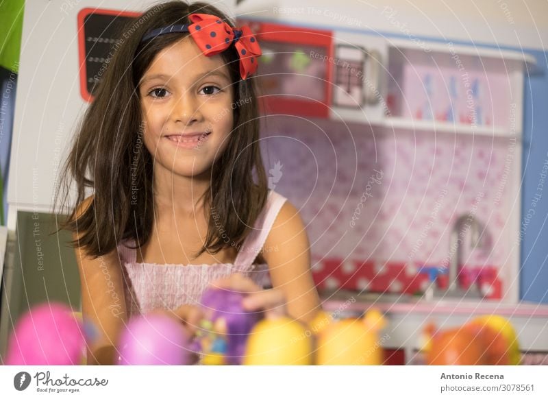 little girl playing i her toy kitchen Lifestyle Playing Child Human being Toys Smiling Sit Happiness Cute muppets symbolic 6s six years old kid Home indoor