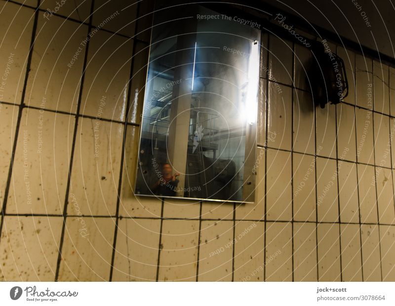 Reflection on a tiled wall Man 1 Cellar Mirror Mirror image Tile Seam Hideous Trashy Gloomy Moody Whimsical Irritation Deferred Distorted Ravages of time Column