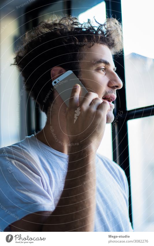 Young man using his smart phone. Lifestyle Happy Work and employment Profession Workplace To talk Telephone PDA Computer Notebook Technology Human being Man