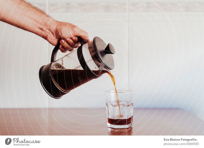 caucasian man serving coffee in a transparent glass Breakfast Beverage Coffee Crockery Spoon Lifestyle Shopping Relaxation Leisure and hobbies