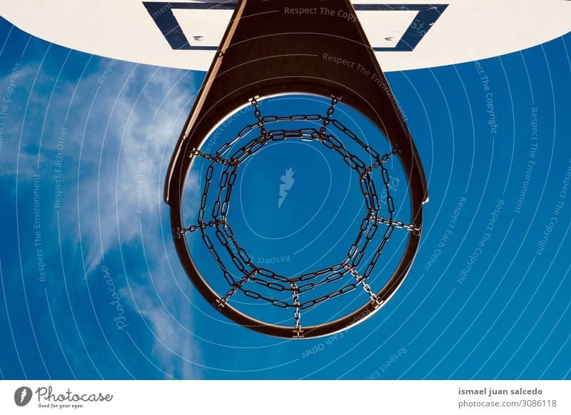 basketball hoop and blue sky in the street Basketball Sky Circle Chain Net Sports Sports equipment Playing Old Street Park Playground Exterior shot Blue Minimal