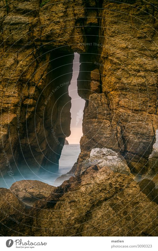 Rock fissure Landscape Water Sky Horizon Sunrise Sunset Summer Beautiful weather Waves Coast Ocean Blue Brown Gray Pink Wall of rock Cervice Cliff Colour photo