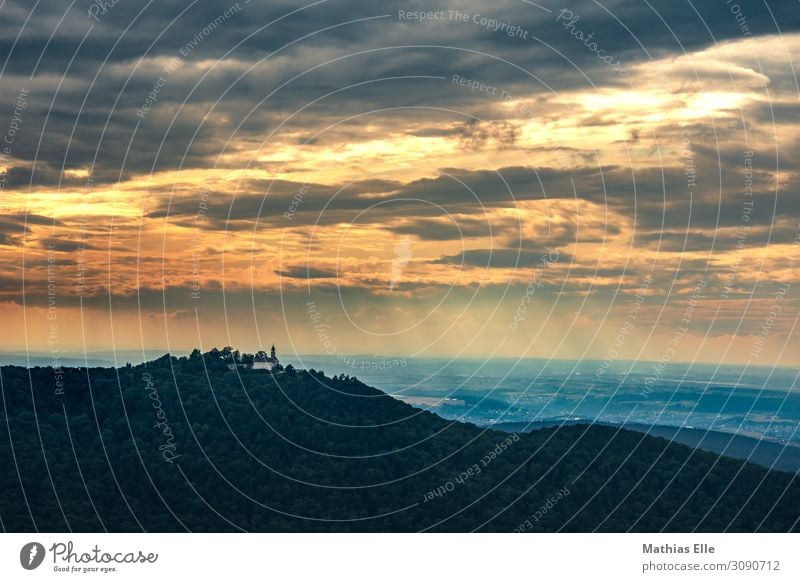 Clouds with sunrays in front of a mountainous foreground Tourism Trip Summer vacation Sun Living or residing Landscape Sky Sunrise Sunset Weather tree hillock