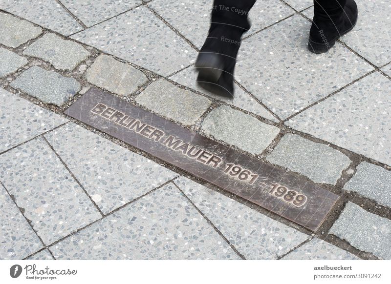 Berlin Wall 1961 - 1989 Lifestyle Tourism Sightseeing City trip Human being Woman Adults Feet Town Capital city Downtown Tourist Attraction Monument Pedestrian