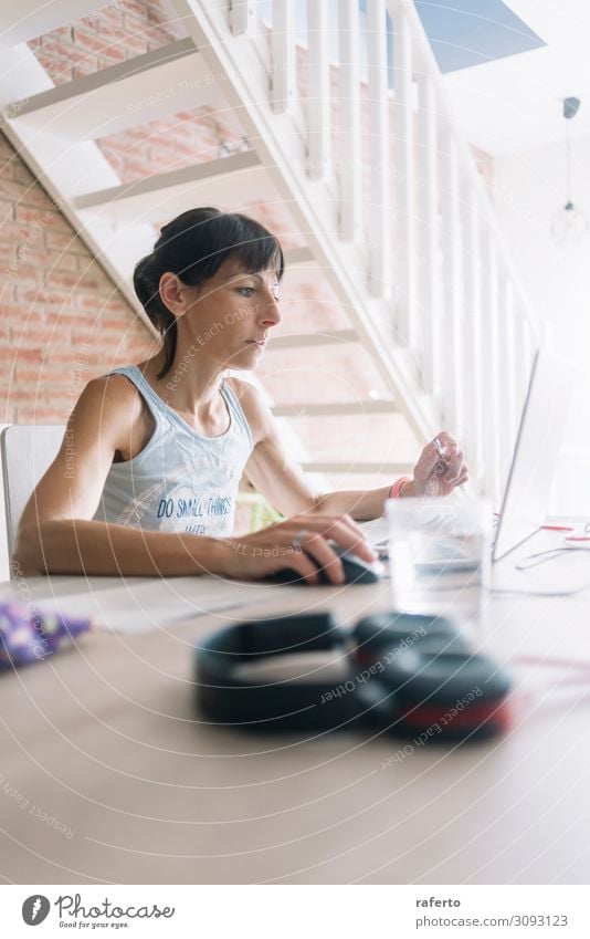 Woman with laptop working at home Coffee Lifestyle Table Work and employment Business PDA Computer Notebook Technology Internet Human being Feminine Young woman