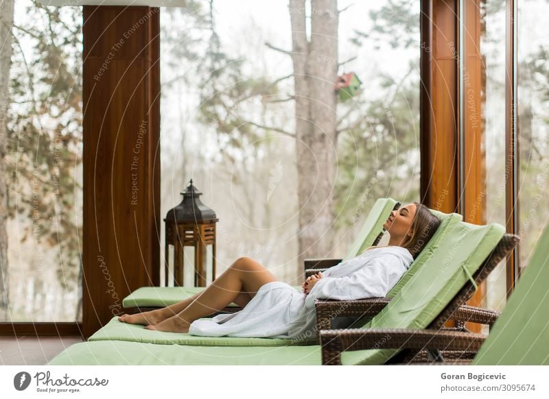 Young woman relaxing on the deckchair by the swimming pool Lifestyle Beautiful Wellness Relaxation Spa Swimming pool Leisure and hobbies Vacation & Travel