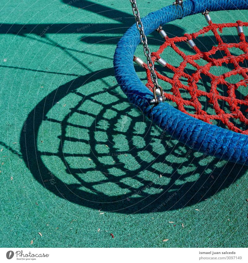 old swing on the playground on the street Swing Playground Playing Playful Joy Park Street Exterior shot Infancy Old Colour Multicoloured Bilbao Spain