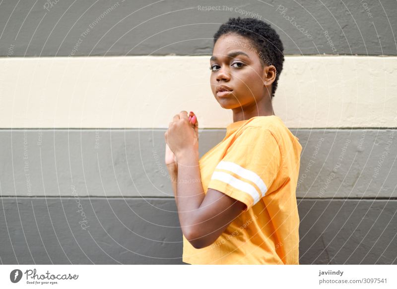 Young black woman with serious expression looking at camera outdoors. Lifestyle Style Beautiful Hair and hairstyles Face Human being Feminine Young woman